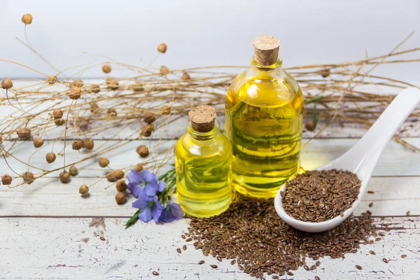 Flores Semillas Botellas Aceite Lino Sobre Madera Blanca — Foto de Stock