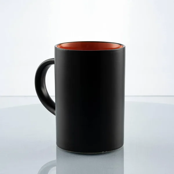 Egy Fekete Csésze Narancssárga Alkalmi Reggeli Fehér Háttér Egy Üveg — Stock Fotó