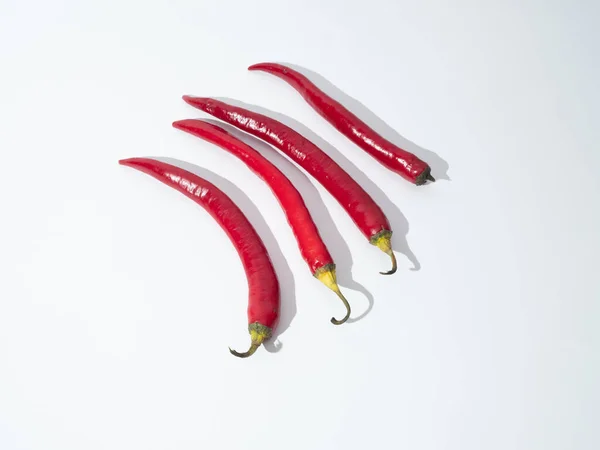 Top View Four Red Chili Peppers White Surface — Stock Photo, Image