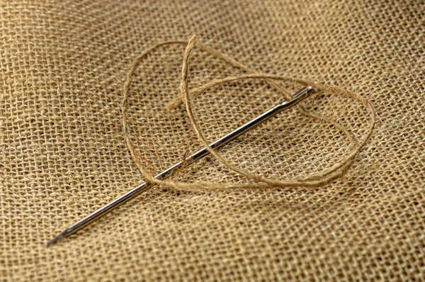 Pull thread into needle Stock Photos, Royalty Free Pull thread into needle  Images