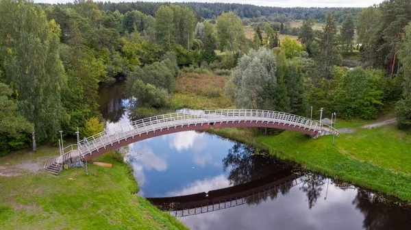 Sebuah Jembatan Melengkung Atas Sungai Biru Dalam Hijau — Stok Foto
