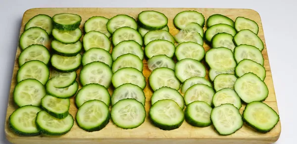 Wooden Chopping Board Covered Slices Cucumber — Stock Photo, Image