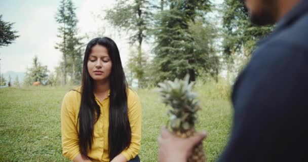 Man Offers Pineapple Woman Enjoying Picnic Park — Stockvideo