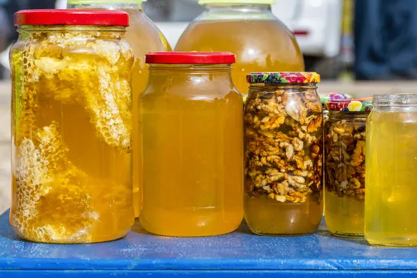 Closeup Shot Bashkir Bee Honey Unpacked Different Glass Plastic Containers — Stock Photo, Image