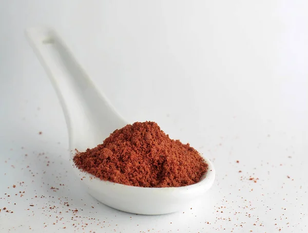 Closeup Red Ground Pepper White Spoon White Background Copyspace Top — Stock Photo, Image