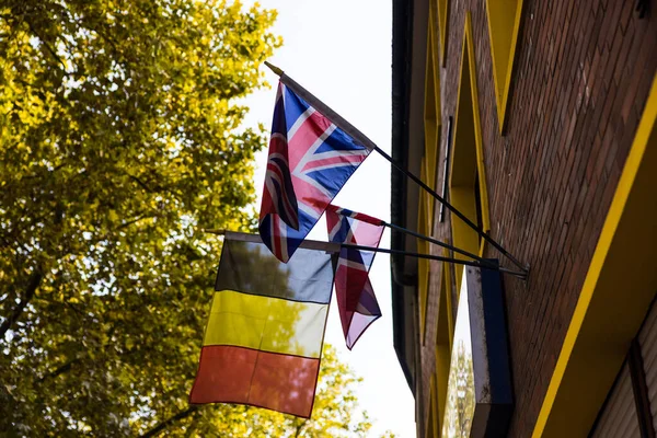 Low Angle Shot Hanging Belgian Flags Building — Stock Photo, Image