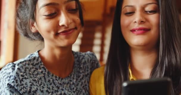 Two Indian Women Sitting Together Using Phone Home — Vídeo de stock