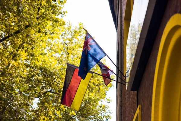 National Flags Germany New Zealand Hanging Flagpoles Building — Stock Photo, Image