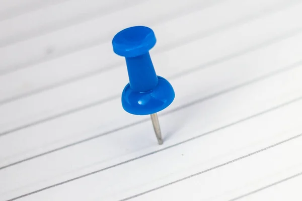 Closeup Blue Pushpin White Sheet Paper Blurry Background Royalty Free Stock Photos