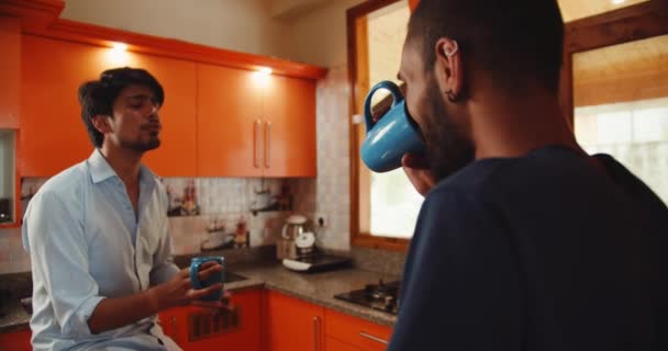 Two Male Friends Talking Together Kitchen Drinking Tea — Video