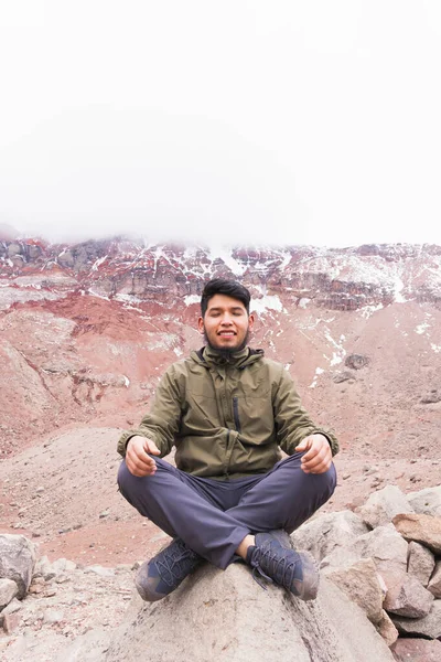 Vertical Shot Young Man Mountains Sitting Rock Meditating — стоковое фото