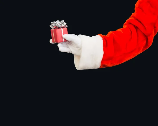 Ręka Świętego Mikołaja Trzyma Pudełko Błyszczącymi Światłami Czarnym Tle Dla — Zdjęcie stockowe