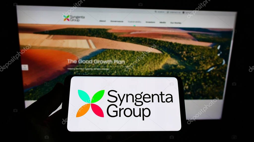 STUTTGART, GERMANY - Jul 04, 2021: Person holding cellphone with logo of Swiss company Syngenta Group on screen in front of webpage. Focus on phone display.