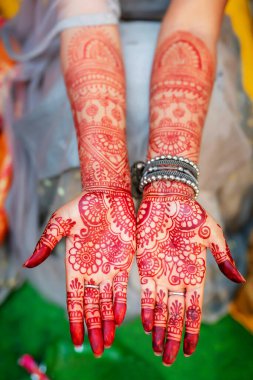 Indian bride showing mehndi design at wedding celebration clipart