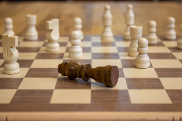 チェスボード上の他の部分の前に落ちた王のチェスの駒の選択的なショット — ストック写真