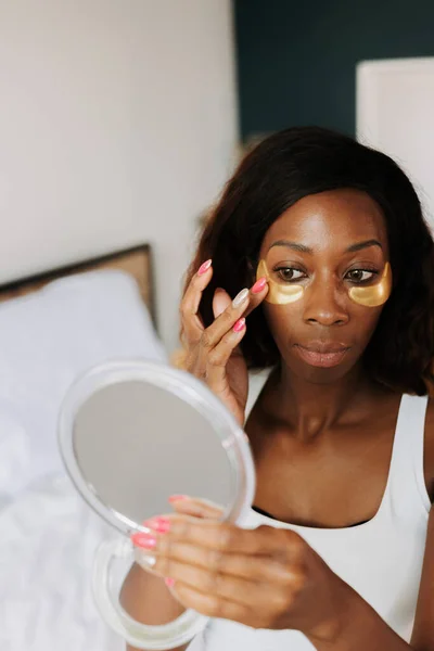 Young Beautiful Black Female Applying Fatigue Eye Masks — Stock Photo, Image
