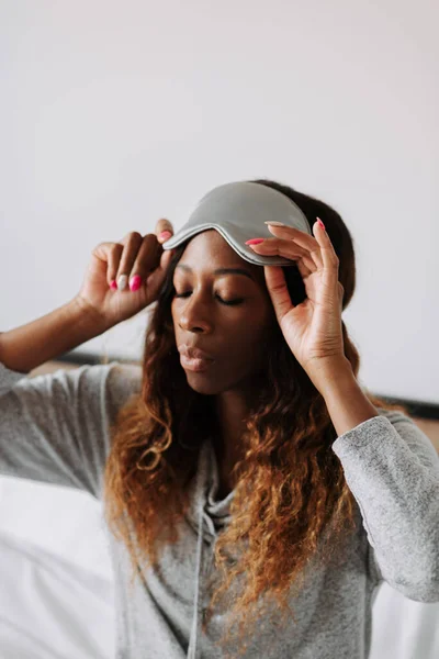 Young Beautiful Black Female Casual Clothes Wearing Sleeping Mask Sitting — Stock Photo, Image