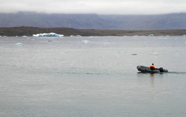 冰河中的一个人 坐着一艘船漂流到冰岛的泻湖中 冰川在后退 — 图库照片