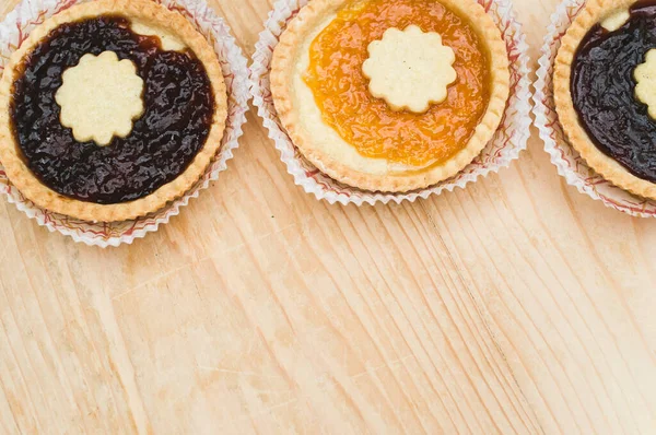 Geïsoleerde Abrikozen Kersenjam Taart Een Papieren Beker Een Houten Tafelblad — Stockfoto