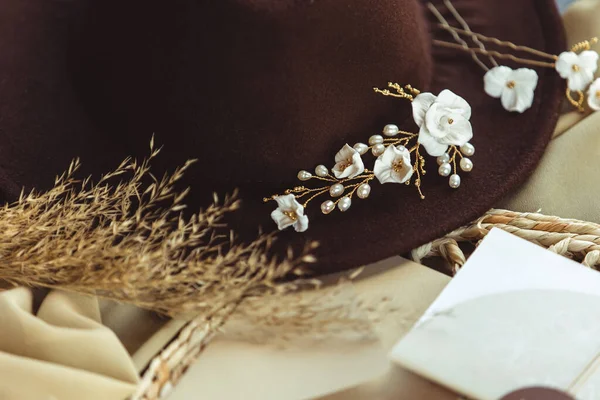 A closeup of a cowgirl hat and flowers, a cowgirl bride