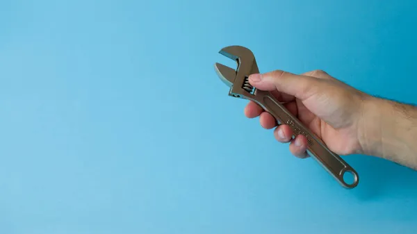 Male Hand Holding Wrench Maintenance Light Blue Background — Stock Photo, Image