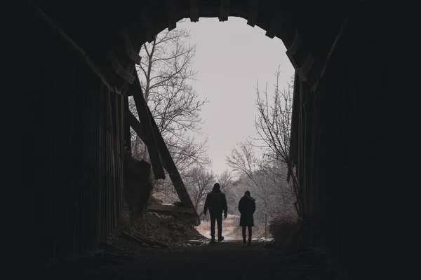 The two people walking through a secret tunnel leading to a park in North Dakota