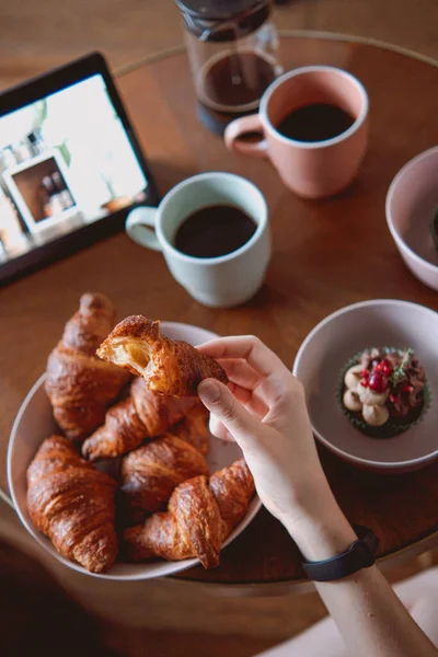 Woman Picking Croissant Bread White Bowls Cupcake Coffee Table — 스톡 사진