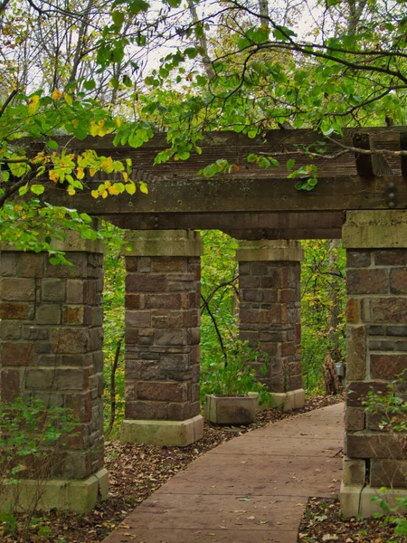 A construction and brick columns by stone walkway in Overland Park Arboretum & Botanical Gardens