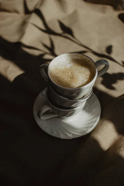 Layer Cups Coffee Milk Foam Beige Background Plant Shadow — стоковое фото