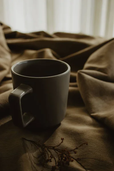 Empty Grey Coffee Cup Dried Orange Beige Fabric Background — стоковое фото
