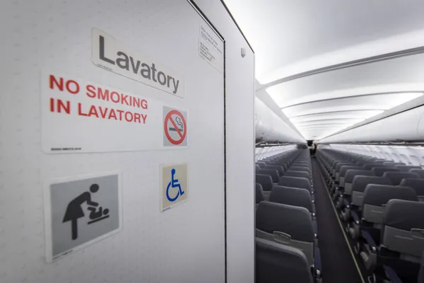 Door of lavatory in an empty aircraft cabin of an Airbus A320