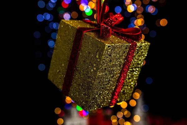 Hanging Gold Sparkly Gift Christmas Ornament Colorful Bokeh Background — Stock Photo, Image
