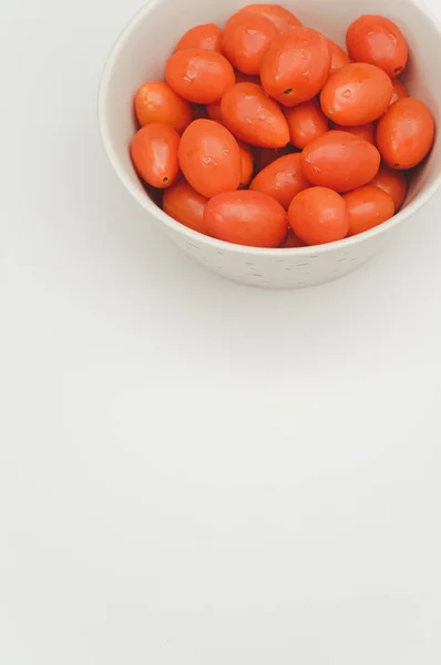 Tazón Gres Decorado Blanco Lleno Tomates Datterini Una Superficie Blanca —  Fotos de Stock