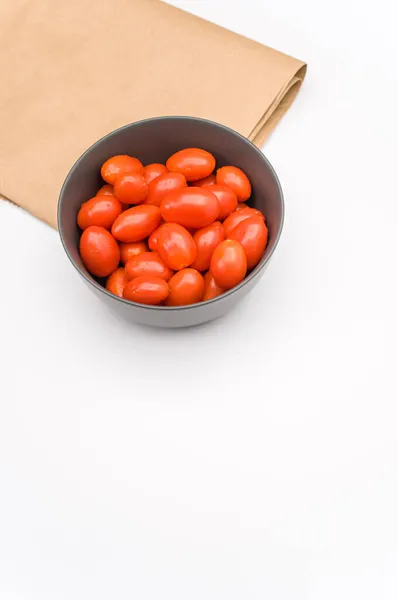 Dark Gray Stoneware Bowl Full Datterini Tomatoes Kraft Paper White — Stock Photo, Image