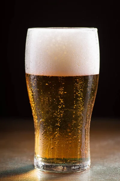 Vertical Shot Glass Cold Refreshing Beer Foam Wooden Table — Zdjęcie stockowe
