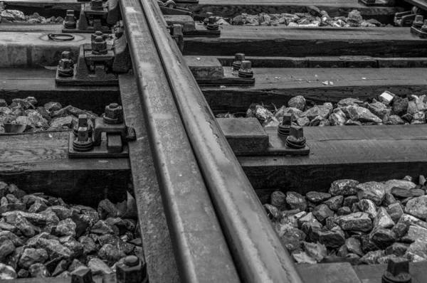 Closeup Shot Tracks Railway Line Grayscale — стоковое фото