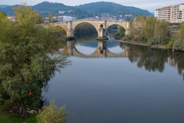 View of the  Roman bridge  and the Minho river in Ourense, Galicia. Spain. clipart