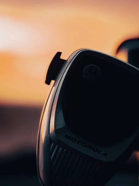 Motorola police radio with sunrise in the background