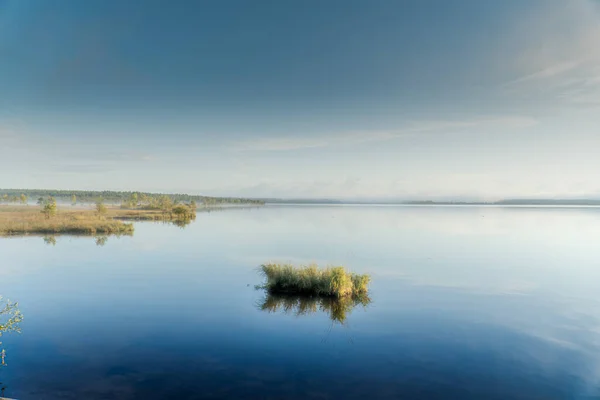 Maličký Ostrůvek Pokrytý Trávou Klidné Hladině Jezera Proti Modré Obloze — Stock fotografie
