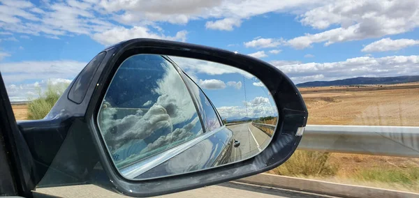 Closeup Shot Road Cloudy Sky Seen Side Mirror Car — стоковое фото