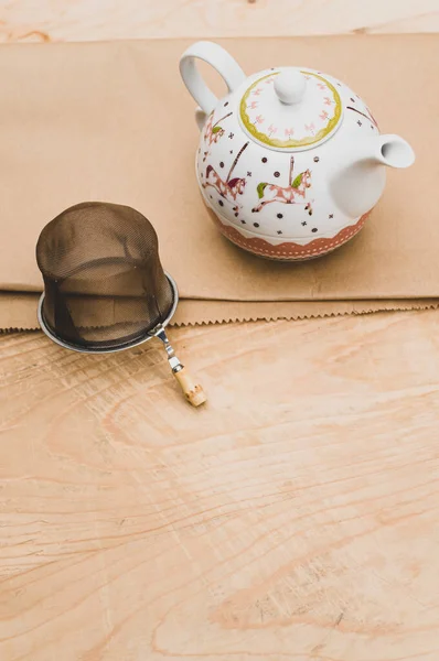 Metal Tea Strainer Decorated Tea Pot Kraft Paper Wooden Background — Stock fotografie