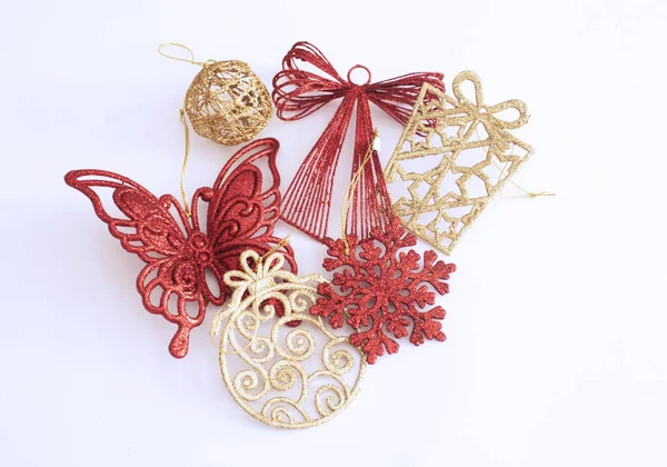 Christmas Ornaments Decorations Red Gold Sparkly Strings Hanging White Background — Zdjęcie stockowe