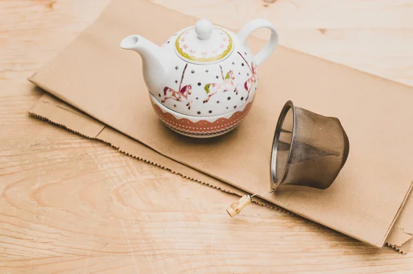 Metal Tea Strainer Decorated Tea Pot Kraft Paper Wooden Background — Stock Fotó