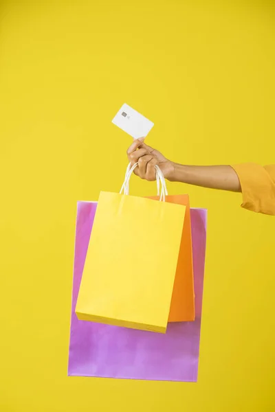 Hand Holding Credit Card Shopping Bags Yellow Background — Fotografia de Stock