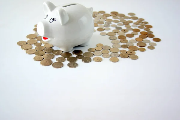 Closeup White Piggy Bank Coins White Surface — Stock Fotó