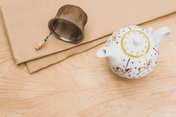 Metal Tea Strainer Decorated Tea Pot Kraft Paper Wooden Background — Stock Fotó