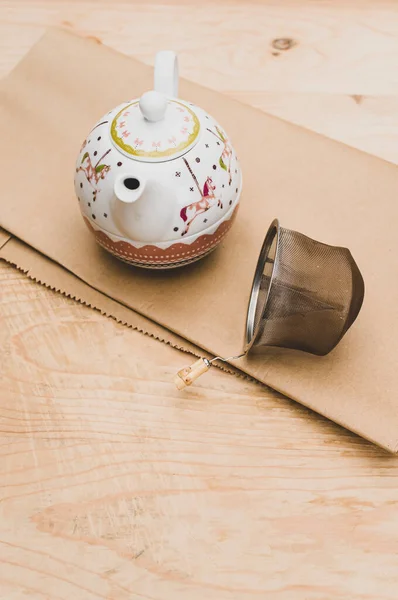 Metal Tea Strainer Decorated Tea Pot Kraft Paper Wooden Background — Stock Fotó