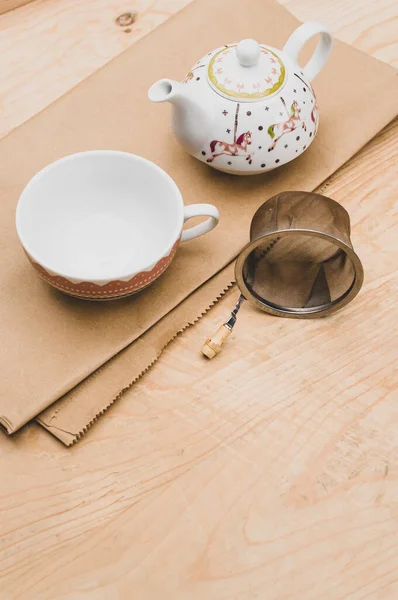 Metal Tea Strainer Decorated Tea Pot Kraft Paper Wooden Background —  Fotos de Stock