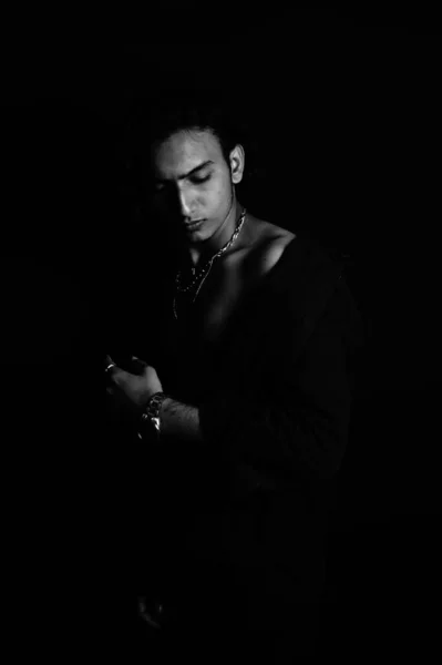 Серый Снимок Стильного Молодого Человека Ювелирных Украшениях Позирующего Темной Комнате — стоковое фото