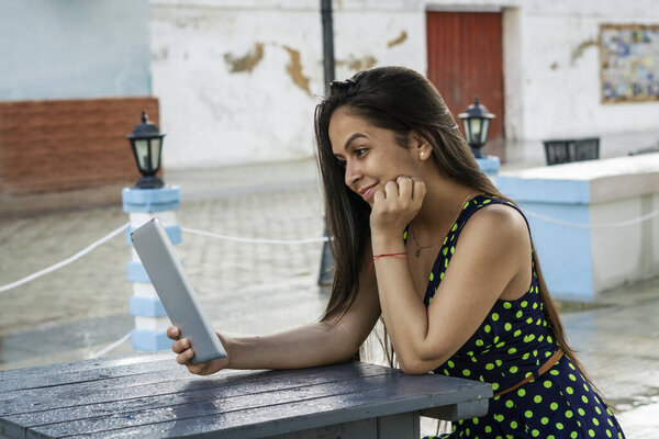 Young Hispanic Female Beautiful Dress Having Video Call Tablet Smiling Royalty Free Stock Images
